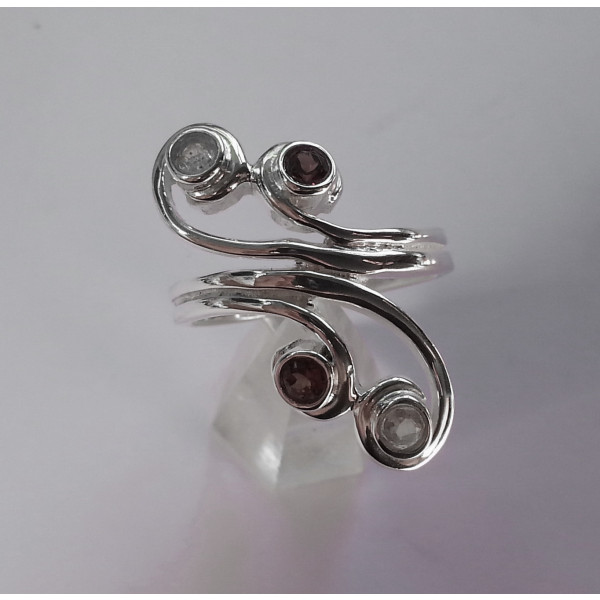 Spirals of sterling silver set with 4 faceted gemstones
